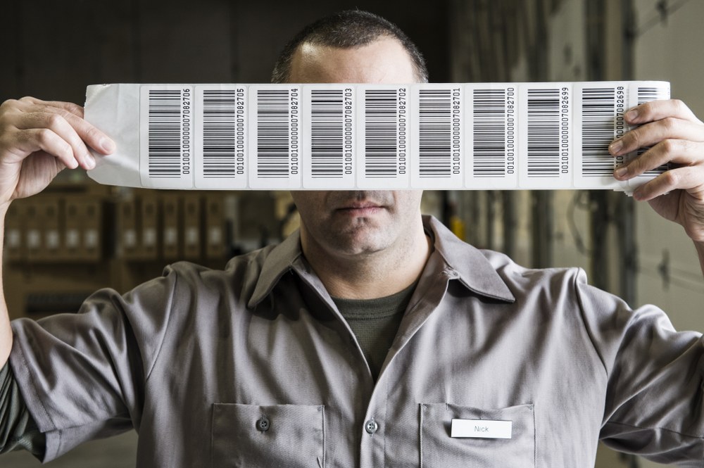 A Warehouse Worker Holding Up A Sheet Of Bar Code 2022 03 04 02 38 20 Utc 1000X665